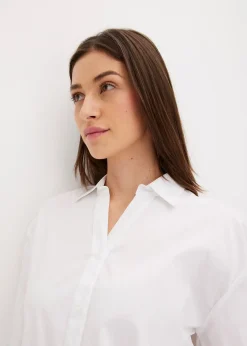 Chemisier court devant, long derrière, manches ballon