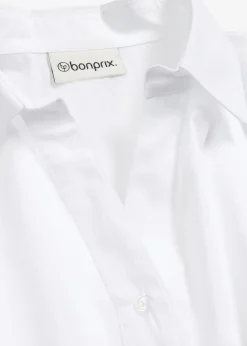 Chemisier court devant, long derrière, manches ballon