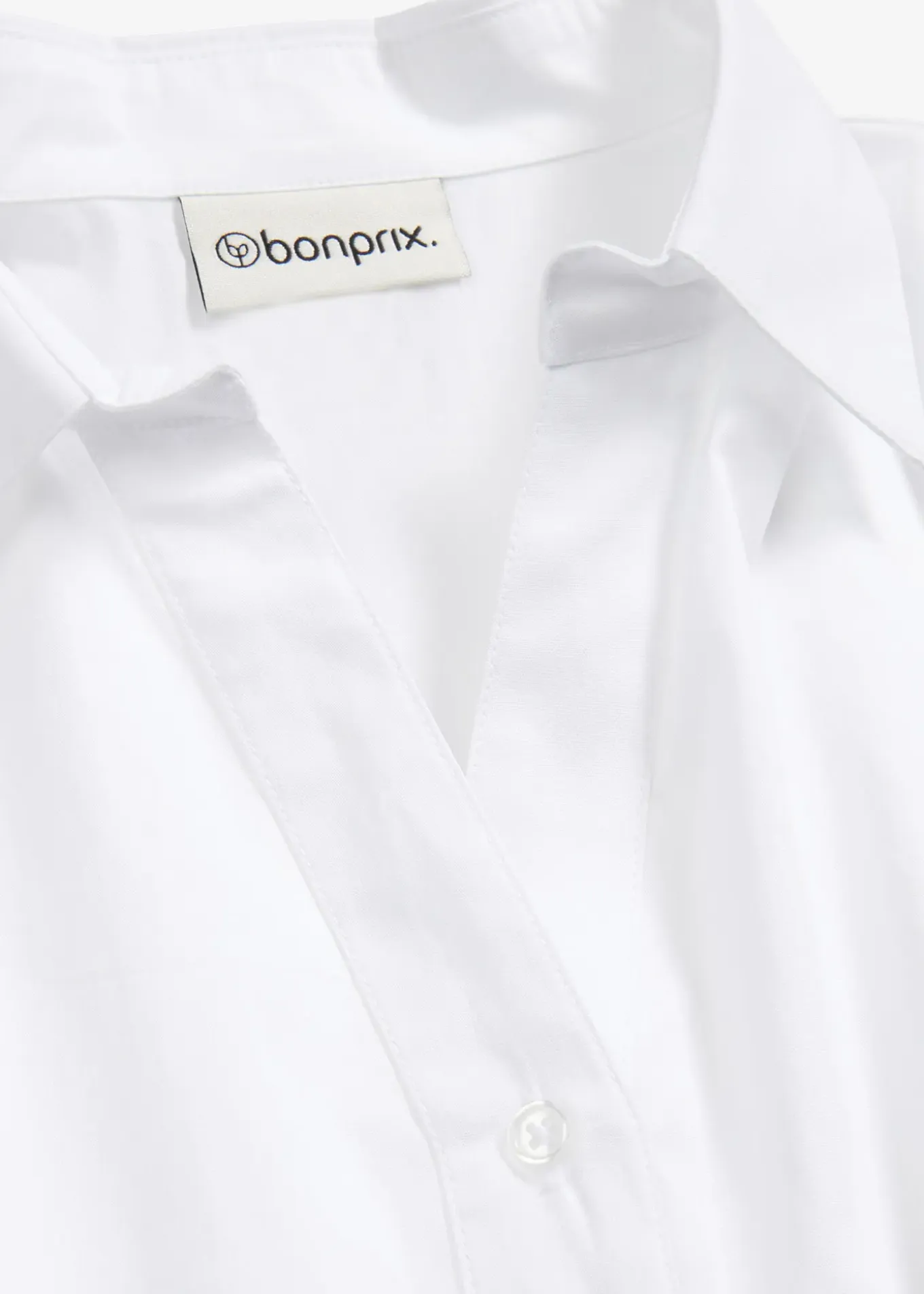 Chemisier court devant, long derrière, manches ballon