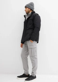 Parka technique imperméable à capuche enroulable et épaulettes