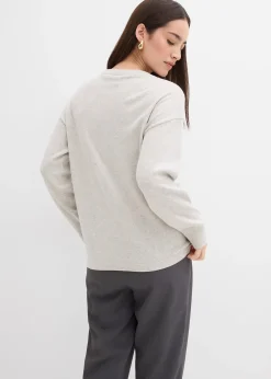 Pull en fine maille à boutons asymétriques